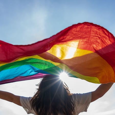 young-woman-waving-lgbti-flag-800x800